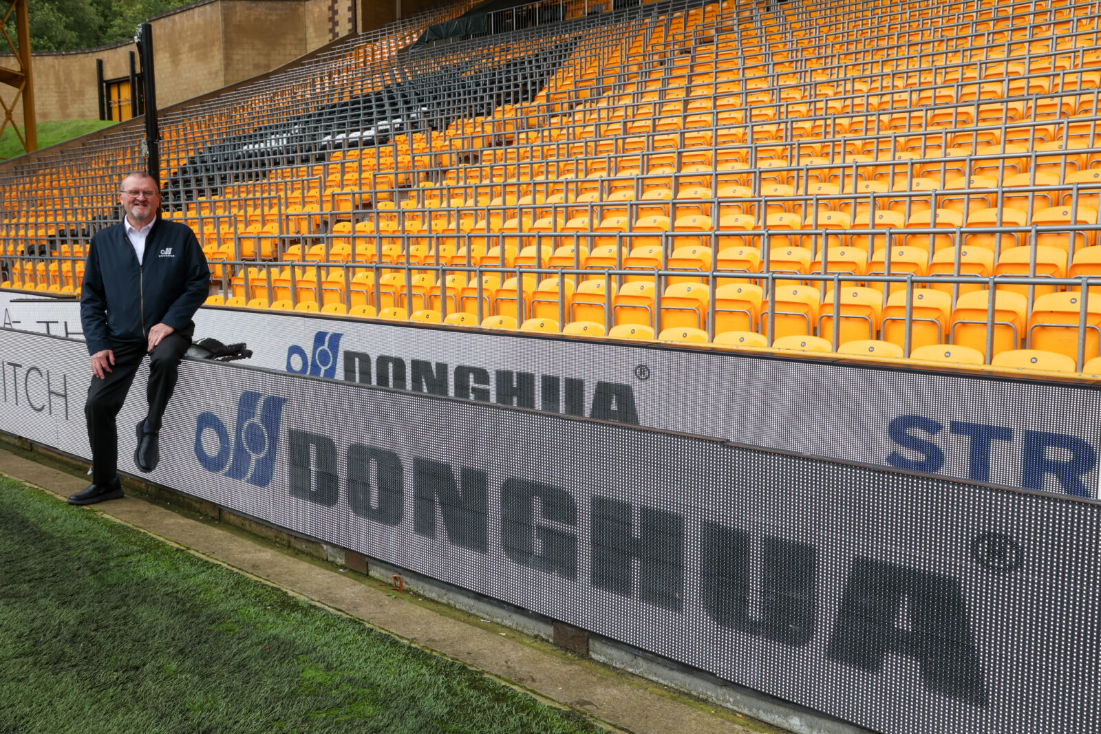 Wolves Business Partner - Bob Wellsbury sitting on side lines